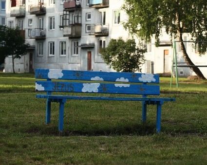 green tree in front of white concrete building by Janis Straume