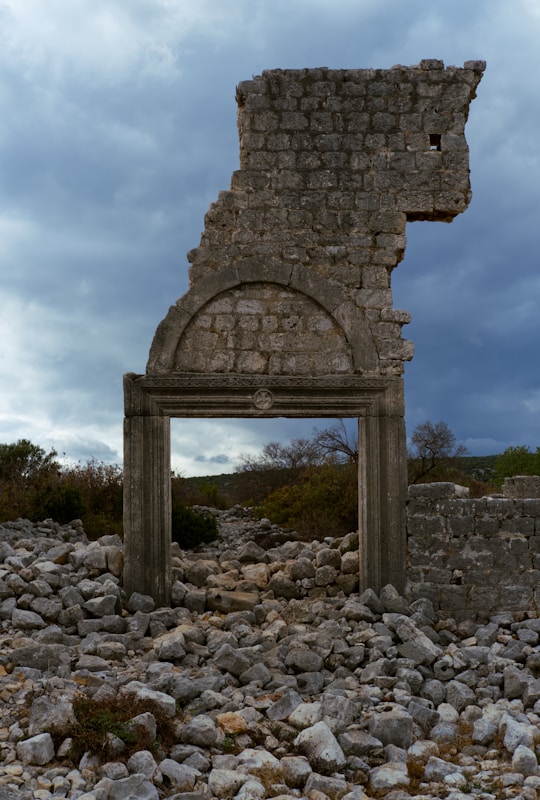A stone chair sitting on top of a pile of rocks
